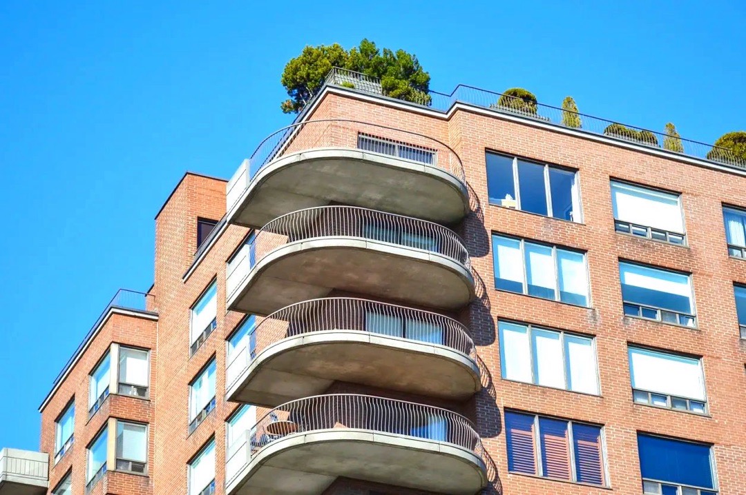 Multi-story brick condo building with balconies