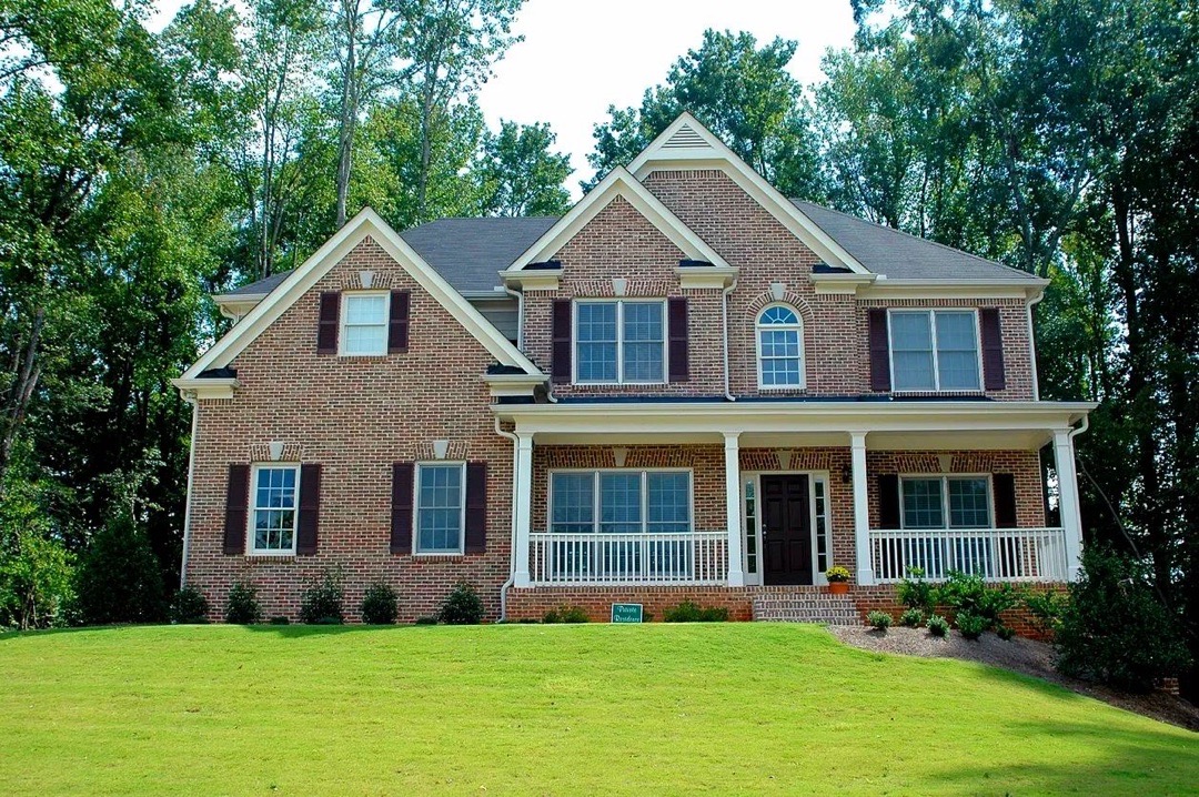 Two-story brick single-family home with a landscaped yard